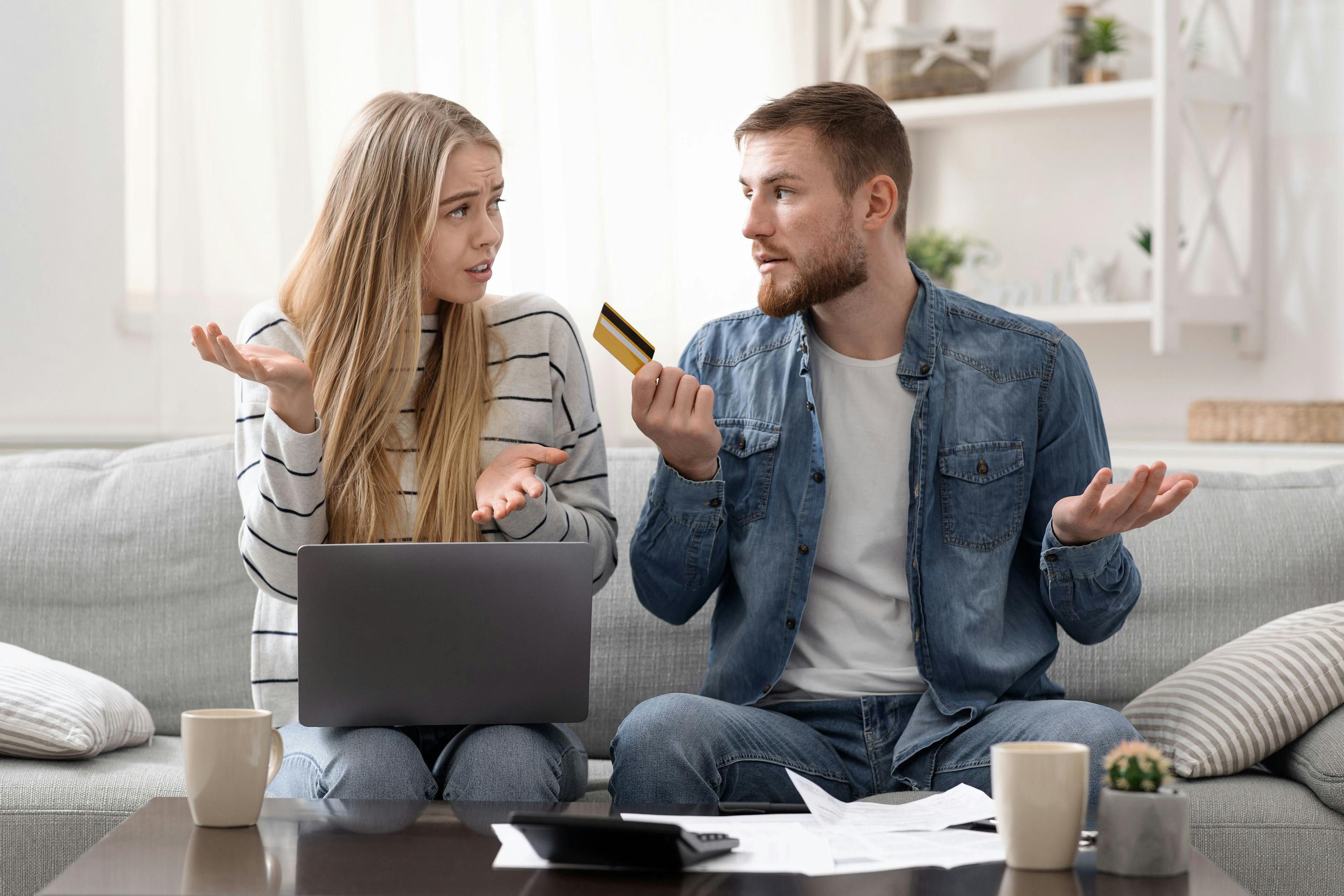 Et kjærestepar som sitter i sofaen og er usikre på om refinansiering av lån uten sikkerhet er det beste valget for de.